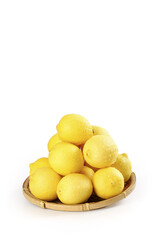 Fresh Yellow Lemons in Bamboo Basket on White Background
