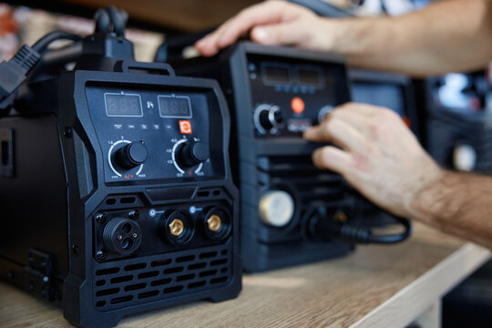 A person is diligently checking a new welding machine