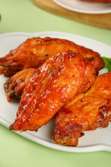 Delicious Crispy Glazed Chicken Wings Bone-In Snack Treat on White Plate