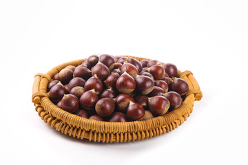 Obraz premium Fresh Chestnuts in Wicker Basket Isolated on White Background