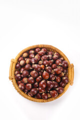 Fresh Chestnuts in Wicker Basket on White Background - Autumn Harvest Nuts