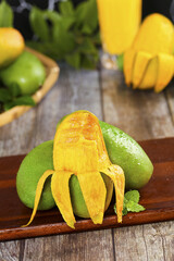 Fresh Tropical Mango and Lime Fruits on Rustic Wood Kitchen Display