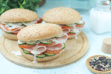 Bun sandwiches with salami and vegetables	