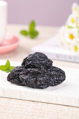 California Dried Prunes with Fresh Mint on Marble Board - Healthy Snack Food Production