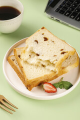 Artisanal Raisin Toast Breakfast Scene with Coffee and Laptop on Bright Green Workspace