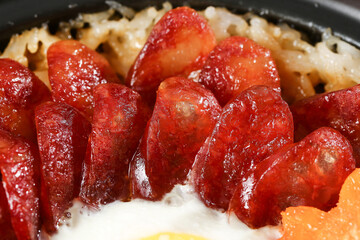 Cantonese Clay Pot Rice Casserole with Preserved Chinese Sausage and Vegetables - Traditional Asian Cuisine