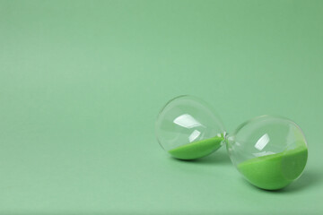 hourglass on a green background
