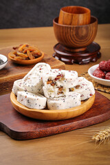 Cantonese Eight Treasures Cake with Walnut and Nuts on Wooden Plate - Traditional Chinese Pastry Dessert