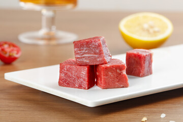 Fresh Diced Raw Beef Cubes on White Plate - Premium Cut Meat Display for Cooking