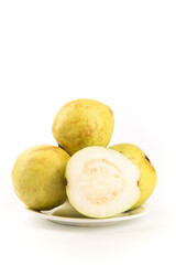 Fresh Guava Fruits Cut in Half on White Plate Showing Creamy Interior