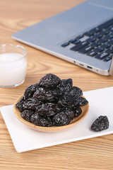 Xinjiang Air-Dried Prunes in Wooden Bowl on Office Desk with Laptop - Healthy Workplace Snack
