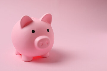 piggy bank, money dollars euros on a pink background
