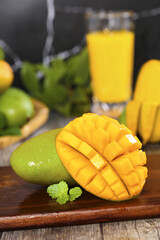 Fresh Mango Cubes with Green Mango and Tropical Juice on Wooden Table