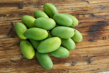Fresh Green Mangoes on Wooden Background - Tropical Fruit Collection