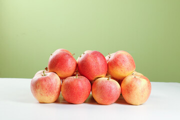 Fresh Red Fuji Apples Group Still Life on White Table Green Background