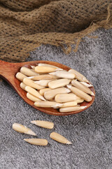 Large Sunflower Seeds from Aksu Xinjiang in Wooden Spoon on Burlap Background