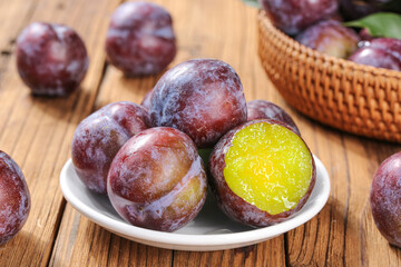 Fresh Red Plums with Yellow Flesh on Wooden Table - Sweet Summer Fruit Display
