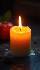 Close-up shot of a lit candle, wax melting and dripping onto a dark surface, creating a warm, inviting ambiance Perfect for autumn, winter, or cozy home themes , hygge, relaxation, heat