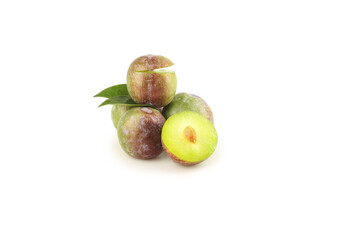 Fresh Sweet Plums with Green Red Skin Cut Half Yellow Flesh Pit Leaf White Background