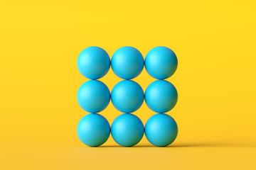 Nine blue spheres forming a square on yellow background