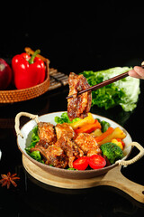 Grilled Lamb Chops with Cumin Seasoning and Crispy Charcoal Coating Served with Fresh Vegetables