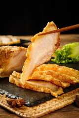 Crispy Cantonese Barbecued Pork with Crackling - Traditional Chinese Cuisine on Wooden Table