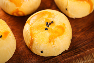 Handmade Custard Egg Tart Pastries with Black Sesame Seeds on Wooden Board - Traditional Asian Dessert Specialties