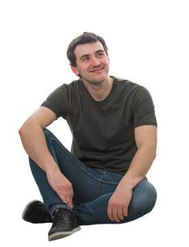 Smart guy sitting on the floor looking away thinking positive, has new ideas, isolated on transparent background