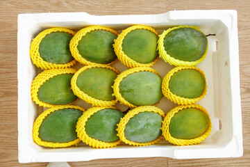 Fresh Green Mangoes in Protective Packaging Box Ready for Market Distribution
