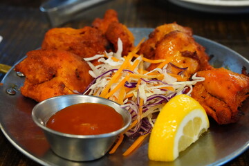 Indian Chicken Tikka Served with Lemon and Salad
