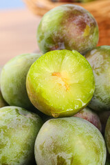 Fresh Green Plums Cut in Half Showing Sweet Juicy Interior