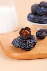 Dried Plums Wild Fruit Snack on Wooden Board - Healthy Natural Food Ingredient