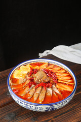Traditional Chongqing Maoxuewang Spicy Chinese Hot Pot with Blood Sausage and Tofu in Porcelain Bowl