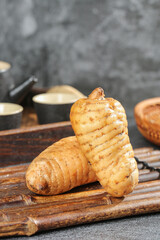 Freshly Dug Chinese Wild Alpine Yam Tubers Rich in Selenium Medicine on Bamboo Board