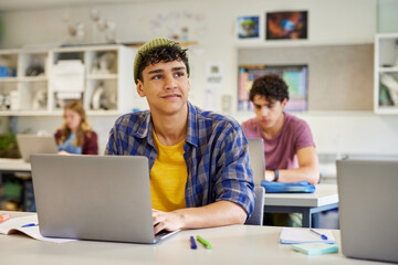 Fototapeta na wymiar Multiethnic guy daydreaming in classroom during lesson