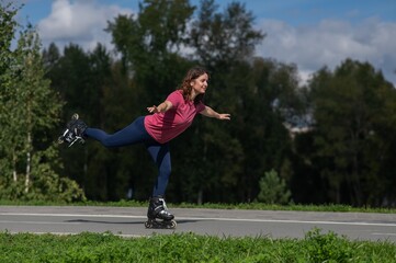 Caucasian woman roller skating in park. 