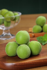 Fresh Yunnan Alpine Plums on Wooden Board - Organic Chinese Stone Fruit Farm Harvest