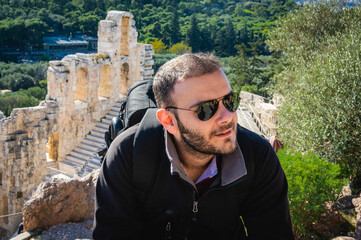 Man posing at Herodes Atticus Odeon in Acropolis, Athens, Greece.