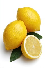 Two whole and one halved lemon, vibrant yellow, with green leaves, on a white background