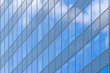 Contemporary office building façade with alternating blue glass and white panels creating rhythm, symmetry, and urban identity.