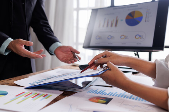 financial Business team analyzing advisory services. Team of advisor showing plan of investment to clients in the consultancy office.
