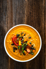 Pumpkin cream soup on wooden table