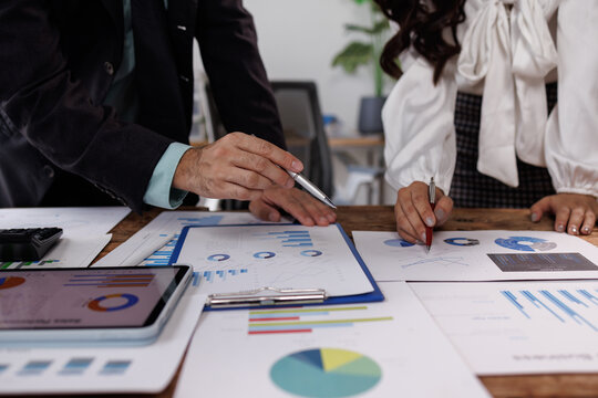 financial Business team analyzing advisory services. Team of advisor showing plan of investment to clients in the consultancy office.
