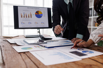 financial Business team analyzing advisory services. Team of advisor showing plan of investment to clients in the consultancy office.
