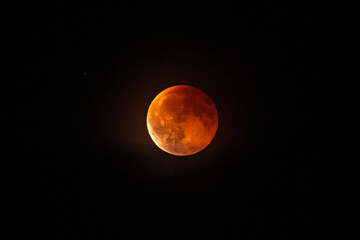 observe the blood moon with shadow of the earth over Austria in a dark night