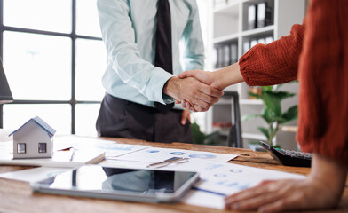 Business partnership asian handshake concept. two coworkers handshaking process.Successful deal after great meeting.Horizontal, blurred background.
