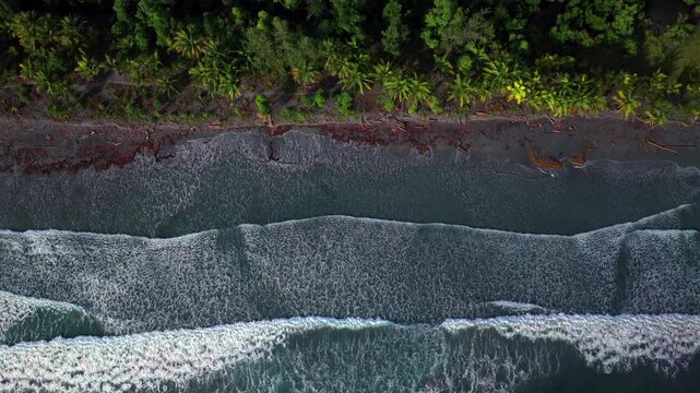 Papua New Guinea untouched remote coastline beach black sand Dogreto Bay large waves swell Wewak Madang PNG aerial drone Birdseye view North New Guinea Papua island Yuo Mushi Island Harbor View upward