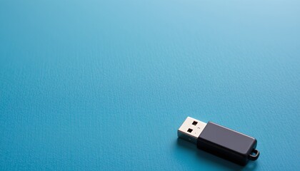 Fototapeta premium A USB flash drive is prominently displayed in front of a plain background.