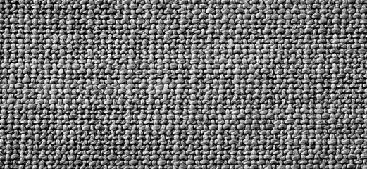 Grey fabric texture pattern on black background