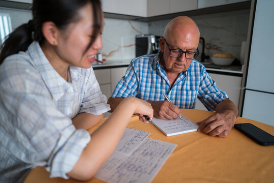 Senior man learning Mandarin with asian woman teacher